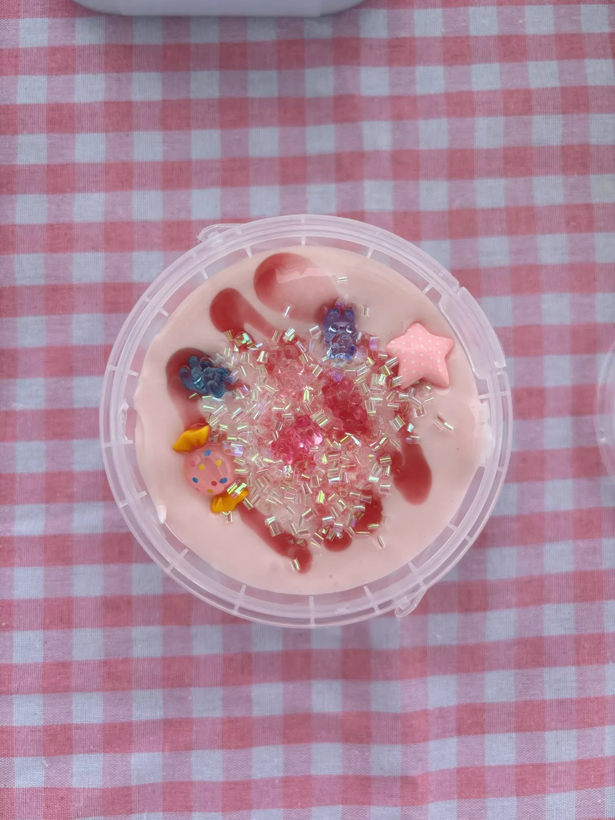 Pink slime with a strawberry swirl, sparkly beads, and a star charm