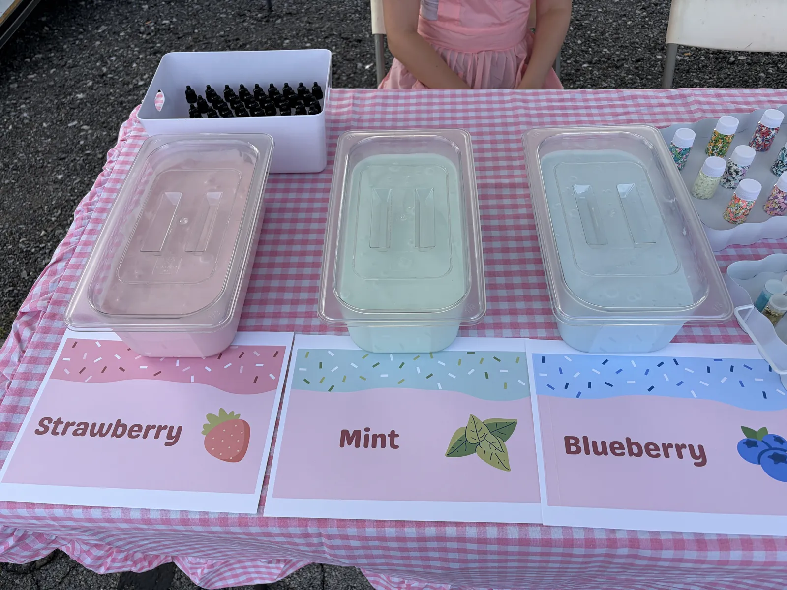 Three tubs of slime labeled Strawberry, Mint, and Blueberry